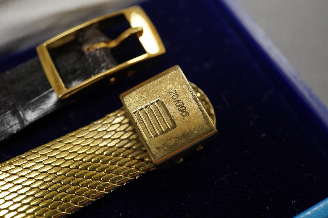 A gentleman's 18ct Girard-Perregaux manual wristwatch, oval brushed gilt dial with raised hour baton marks, seventeen jewels movement, signed, on an associated gilt metal articulated bracelet, in original case.